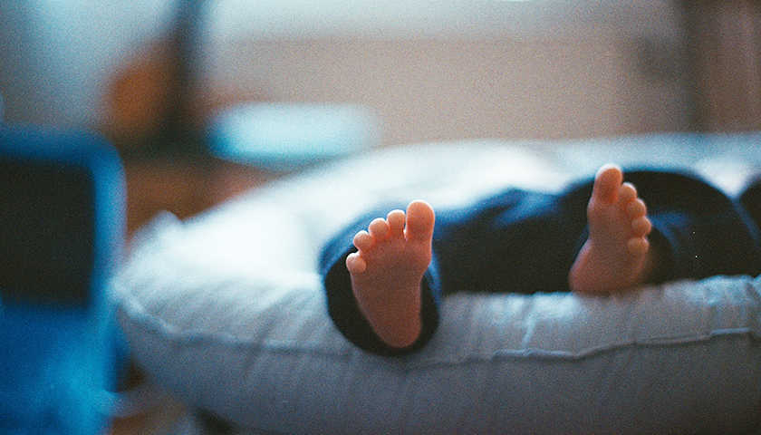 Close up of baby feet lying in bed