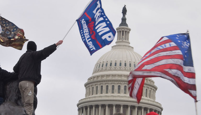 Close up of Capitol with Trump and America flag in the wind