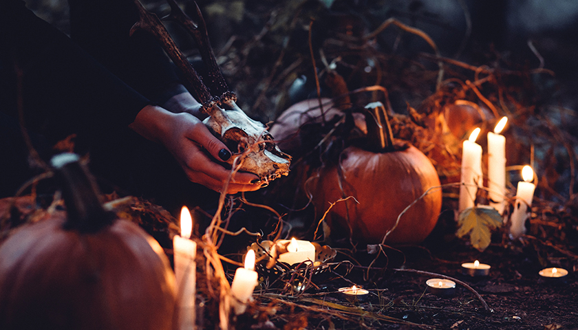 Person decorating with candles and pumpkins