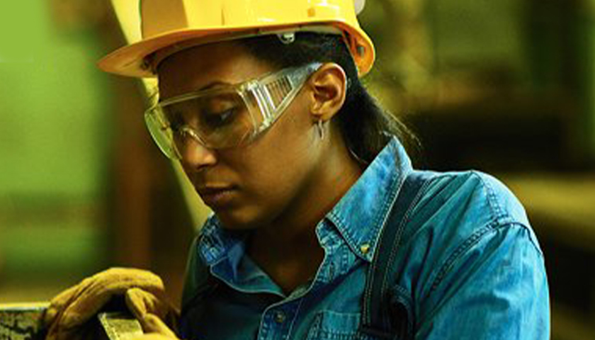 woman with a hard hat and safety glasses on