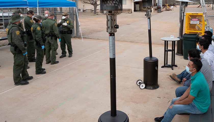 U.S. Customs and Border Protection operations following the implementation of Title 42 USC 265 at the northern and southern land borders. U.S. Border Patrol agents use personal protective equipment as they prepare to process a group of individuals encountered near Sasabe, Ariz. on March 22, 2020. CBP Photo by Jerry Glaser